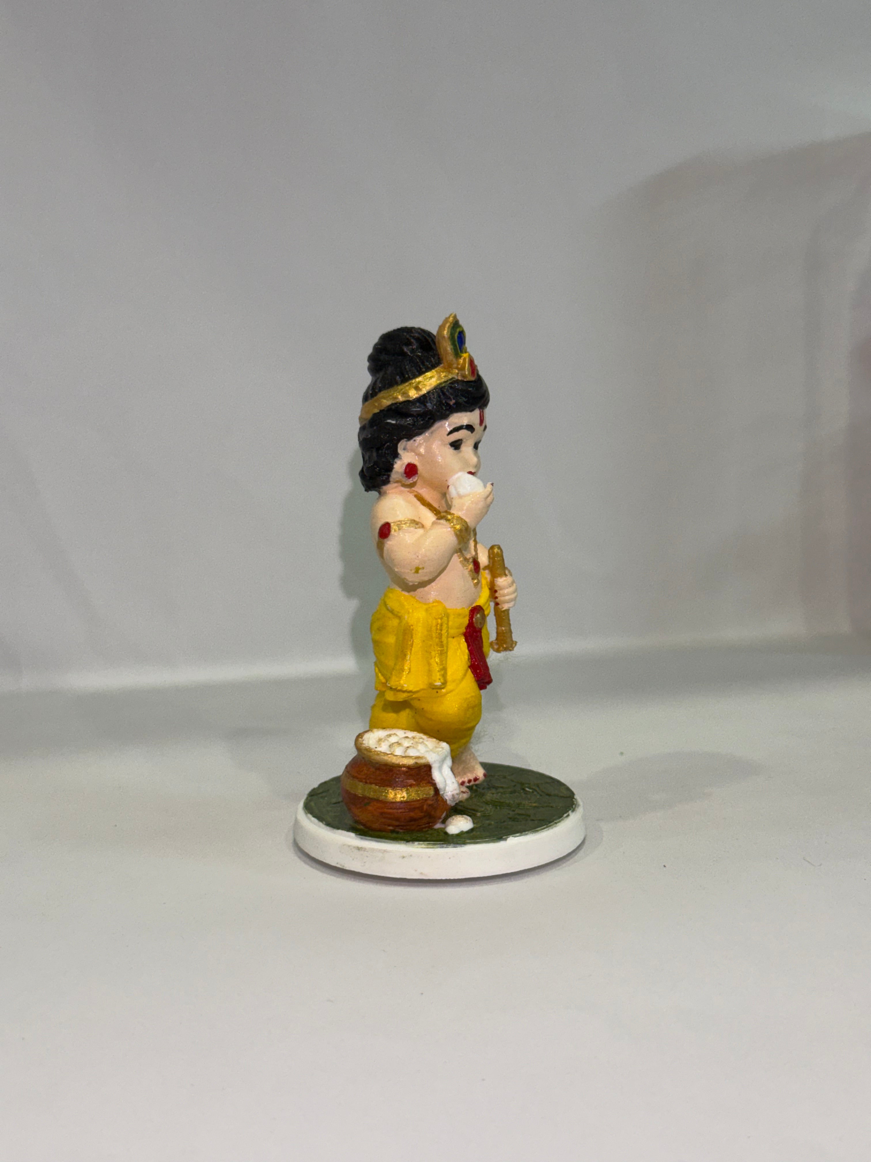 Captures the classic, beloved "Makhan Chor" pose—complete with the traditional pot of butter (matki), flute, and peacock feather crown.