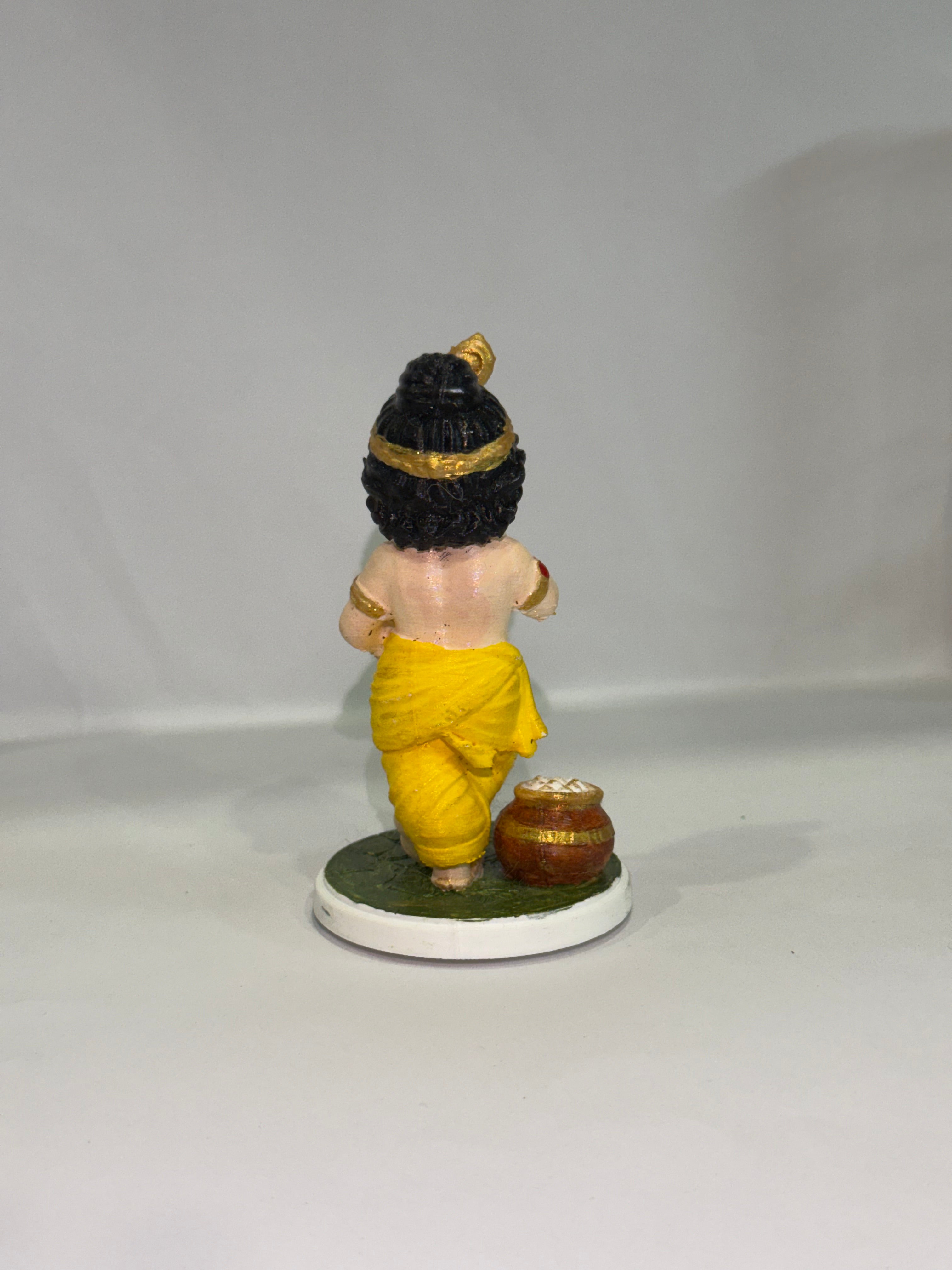Captures the classic, beloved "Makhan Chor" pose—complete with the traditional pot of butter (matki), flute, and peacock feather crown.